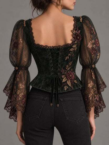 Front view of embroidered floral corset top with sheer gathered sleeves