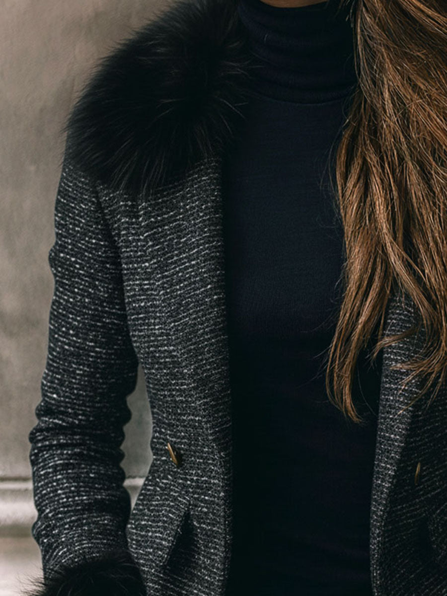 A Black Puffer Jacket With Gold Chain Trim, Zippers, And Buttons On The Sleeves